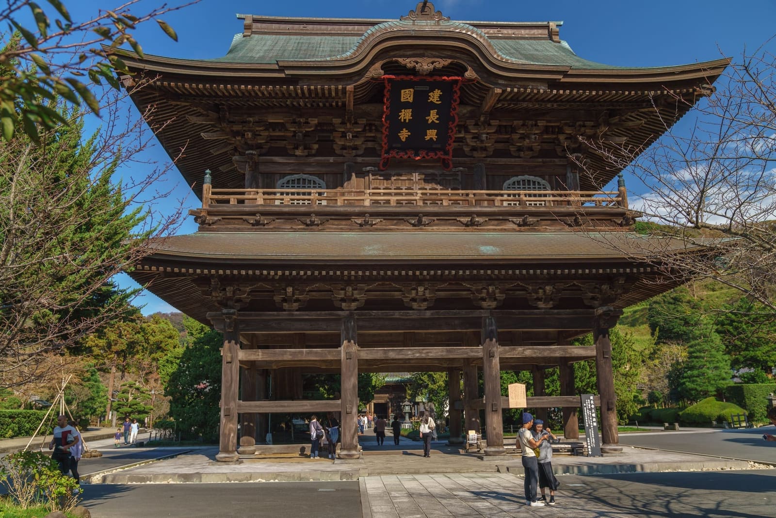 Sanmon gate of Engaku-ji in Kita-Kamakura, with the temple's carved stone name pillar and green maple trees