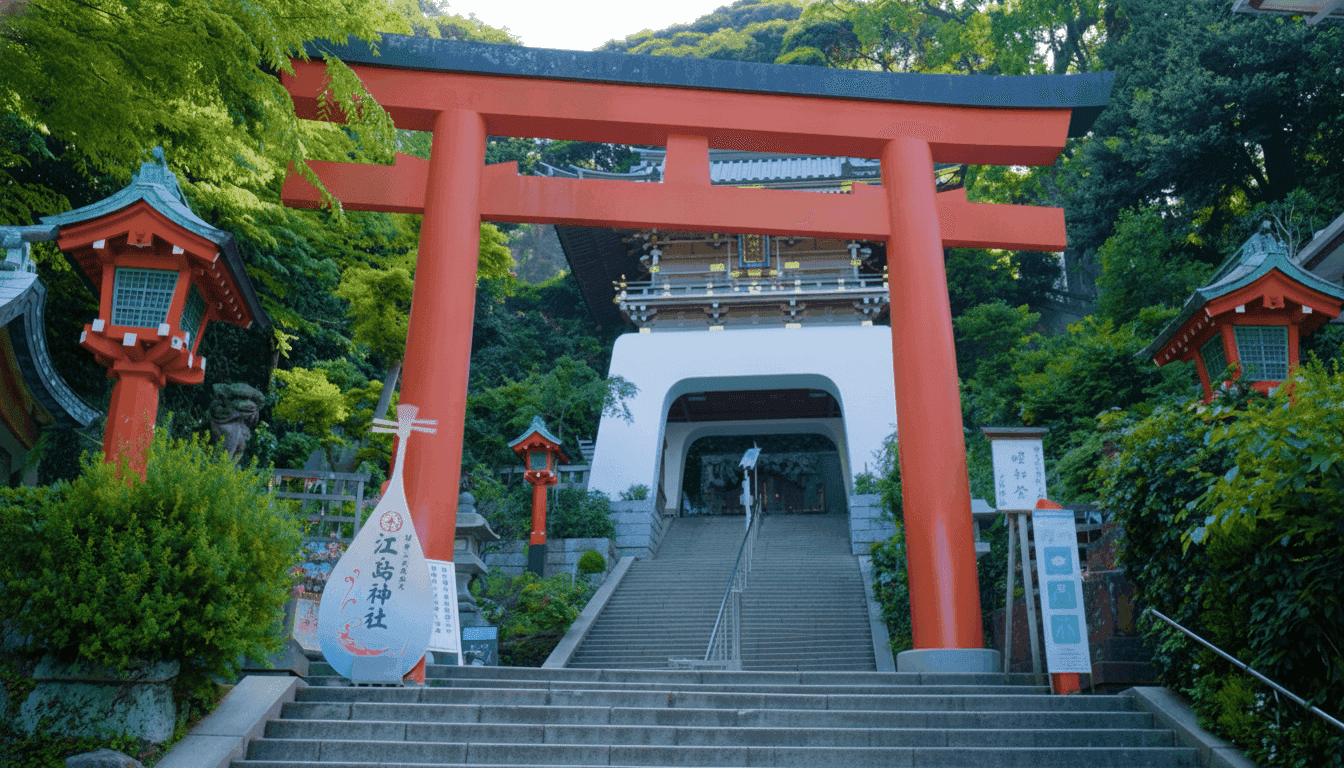 Enoshima Shrine's bronze torii gate and stone staircase leading up to the shrine buildings
