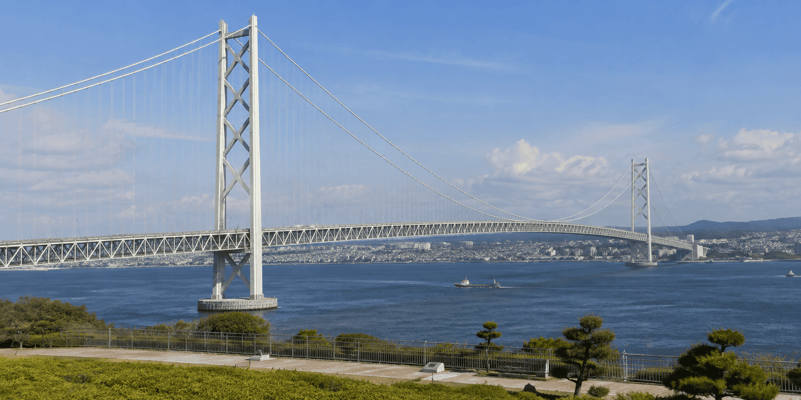 Akashi Kaikyo Bridge's suspension towers and cables spanning the Akashi Strait between Kobe and Awaji Island, viewed from the Kobe-side shore