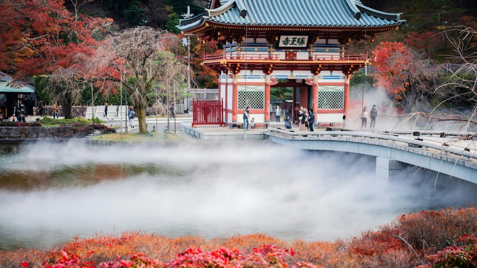 Minoo Waterfall cascading 33 meters into a rocky basin surrounded by dense forest and autumn foliage, Osaka Japan