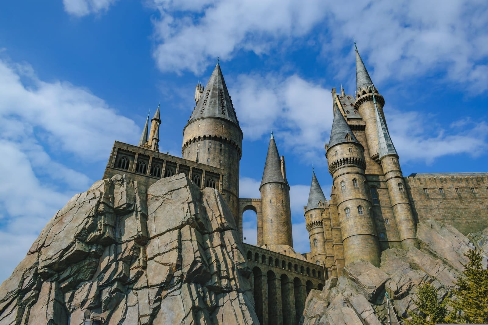 Hogwarts castle towers above rock formations in The Wizarding World of Harry Potter at Universal Studios Japan, Osaka