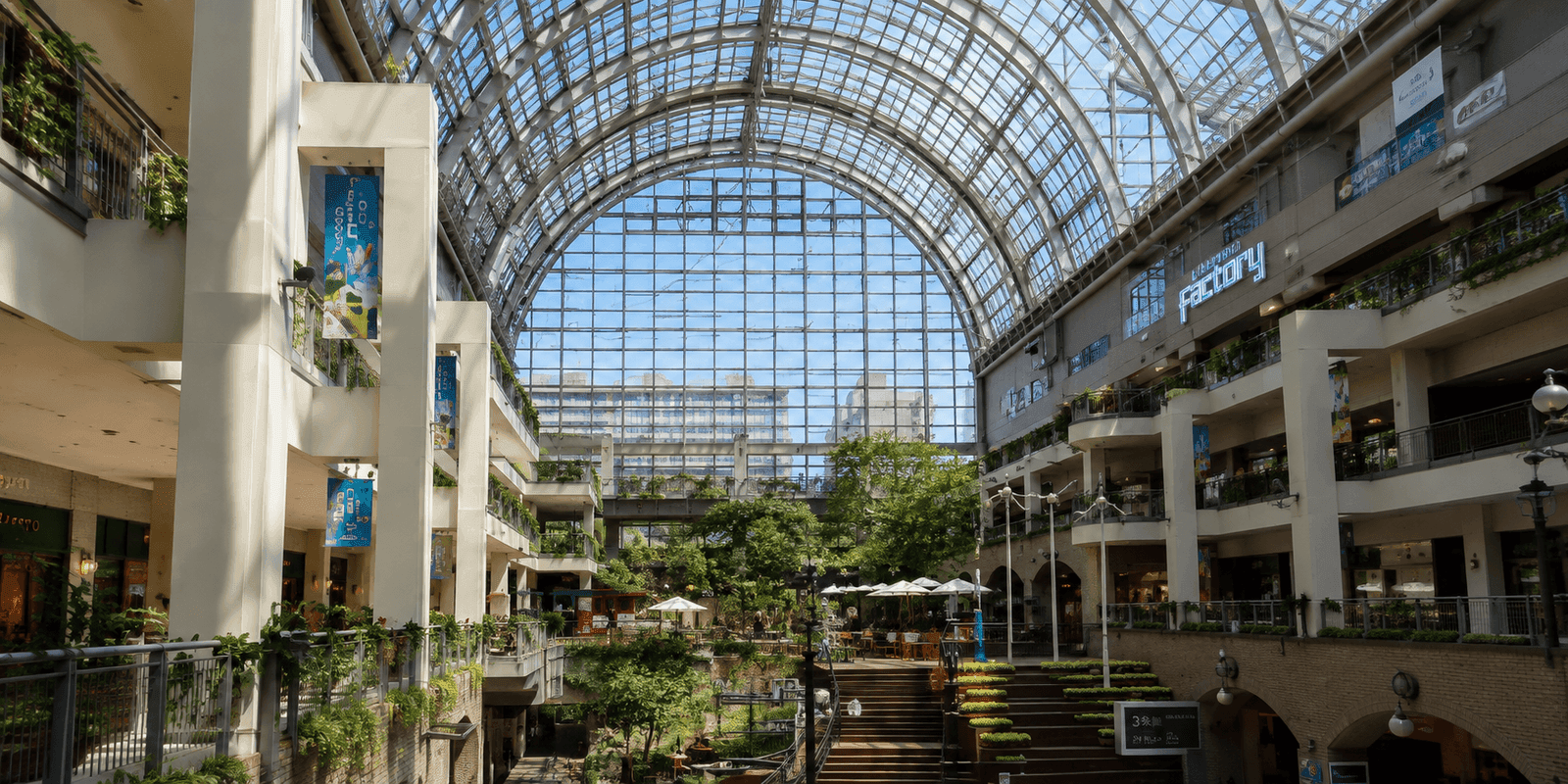 The glass atrium and historic brick buildings of Sapporo Factory shopping complex