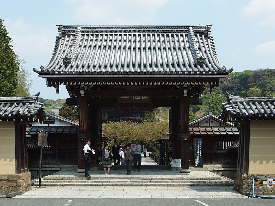 Visitors walking through the Somon, Kencho-ji's outer gate, in spring