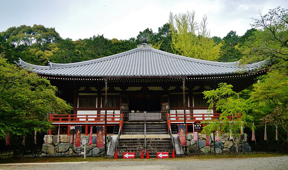 The Kannon-do hall at Daigo-ji, raised on a stone base with vermilion railings, among spring greenery