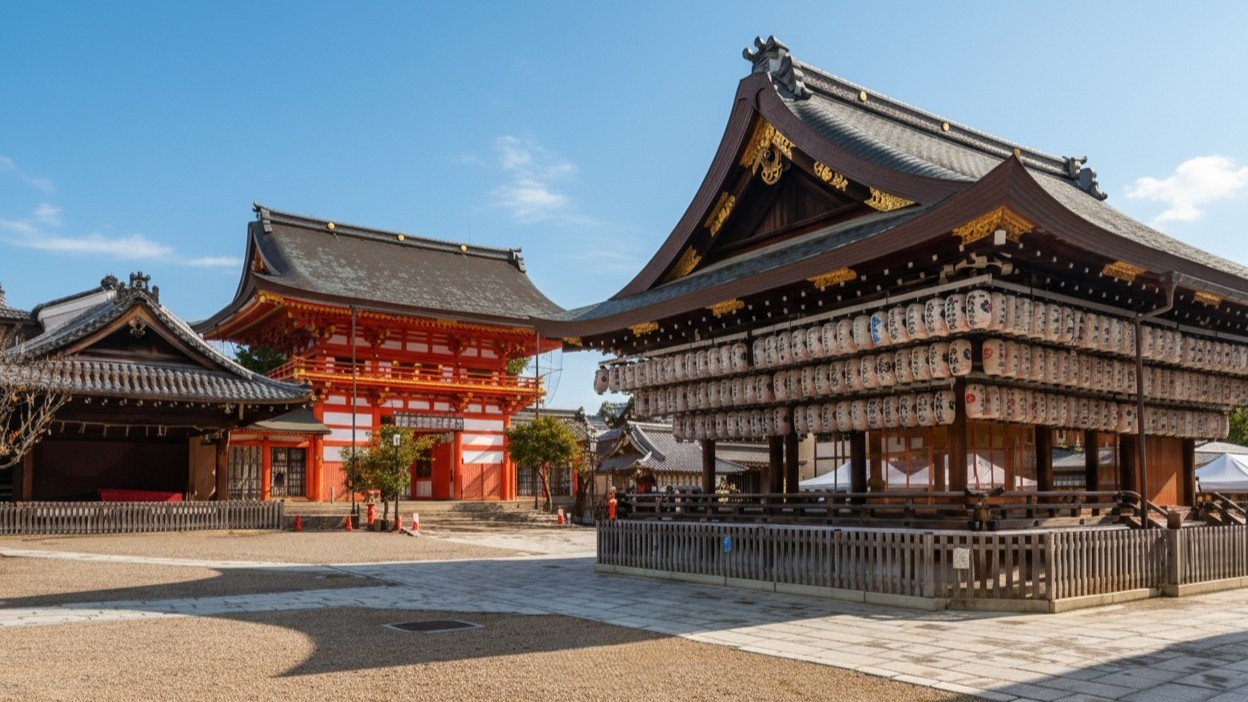 The dance hall at Yasaka Shrine hung with rows of paper lanterns, with a vermilion two-story gate behind